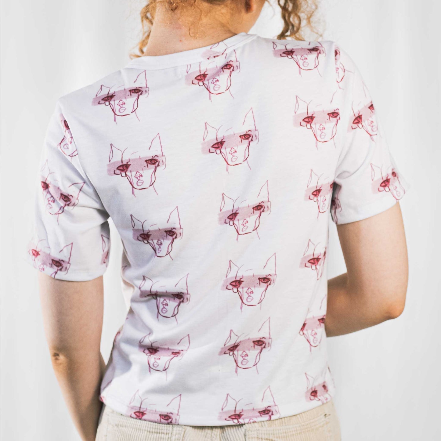 Fashion model wearing illustrated print of pink pig on a white jersey short sleeved T-Shirt.