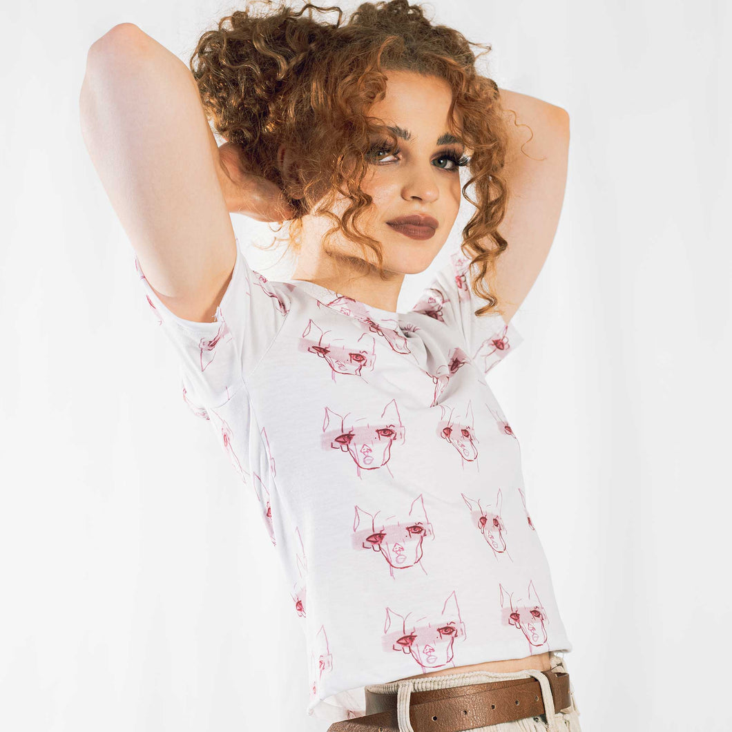 Fashion model wearing illustrated print of pink pig on a white jersey short sleeved T-Shirt.