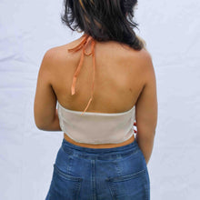 Load image into Gallery viewer, Back view of fashion model wearing Cream coloured cami top with beige lace trim and orange elasticated straps around the neck and bust.
