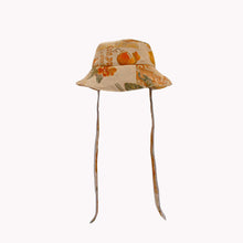 Load image into Gallery viewer, Beige floral bucket hat with fabric straps to tie around the neck.
