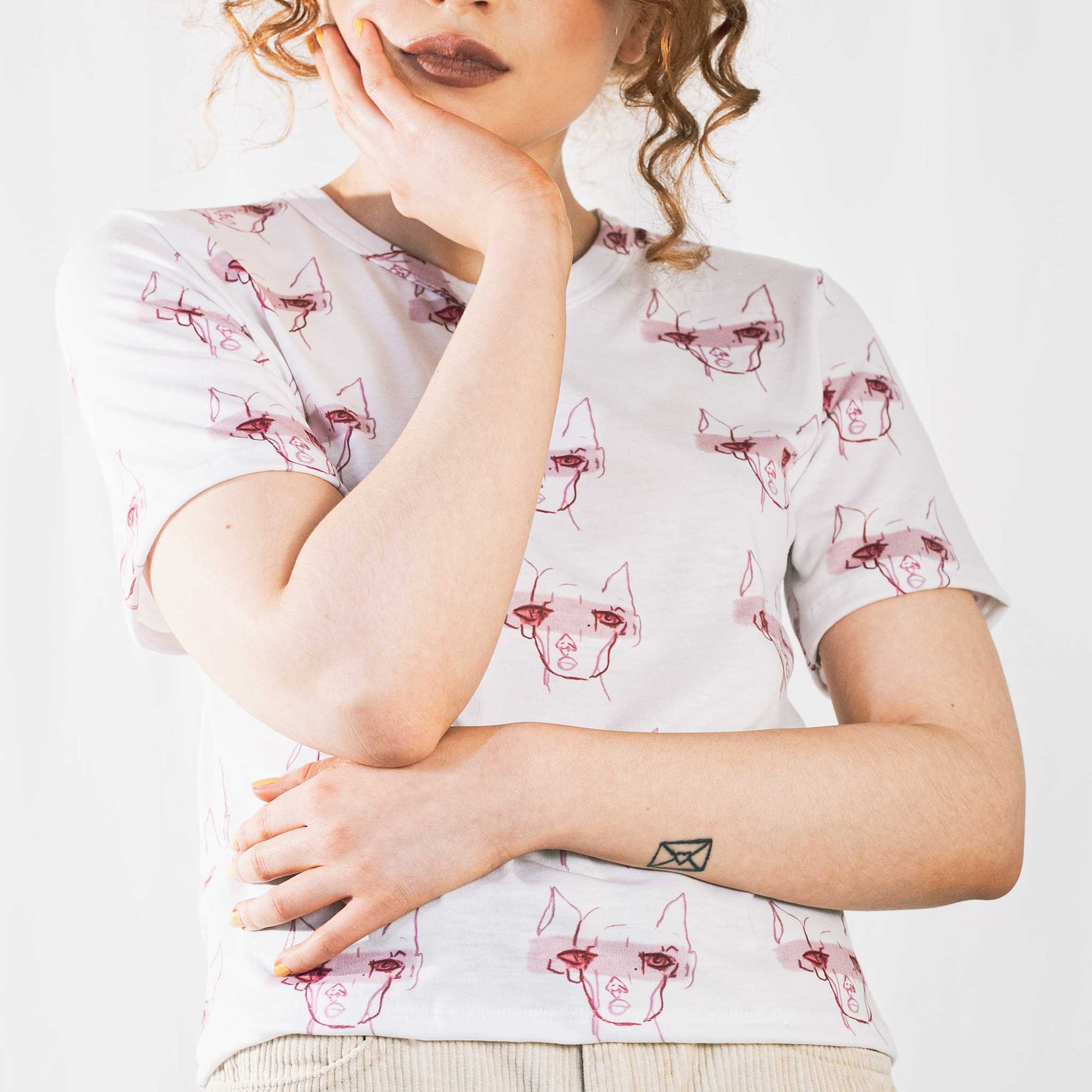 Fashion model wearing illustrated print of pink pig on a white jersey short sleeved T-Shirt.